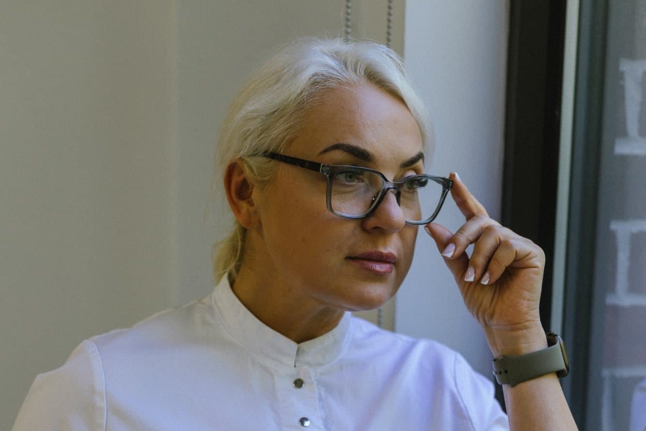 Olena Burykina, founder of LINEL, by a window at the salon in Matthews